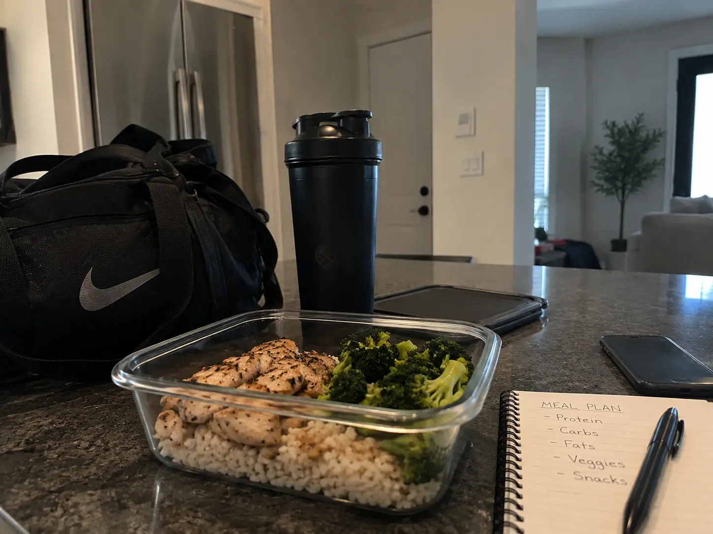 A gym bag and shaker bottle packed for the day